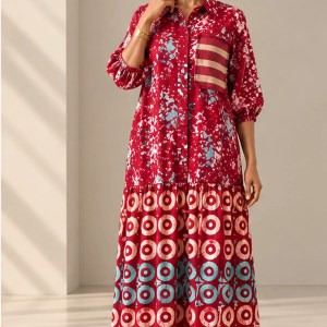 Front view of Shade African Print Maxi Dress in red with blue and cream motifs, featuring a shirt collar, gathered sleeves and tiered skirt.